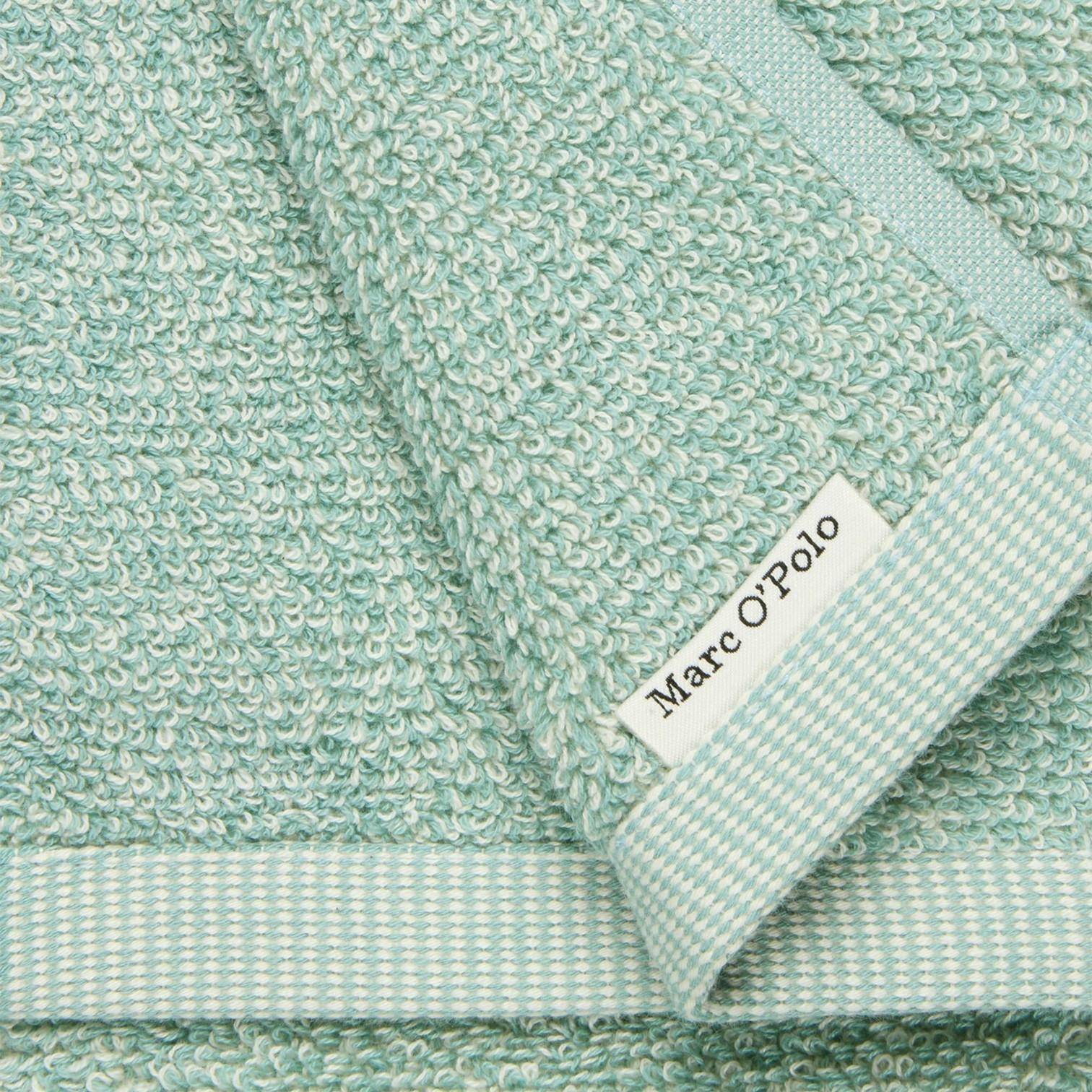 Detail mit MARC O’POLO Label am Gästetuch Timeless Melange Aquamarine 30x50 cm aus Baumwoll-Frottee